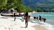 Alle helfen mit, wenn der Fang an Land gebracht wird, Beau Vallon Strand, Mahé, Seychellen